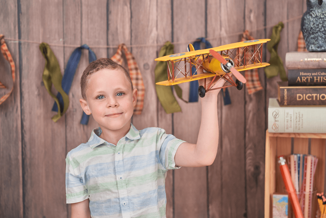 Child playing with toy plane.